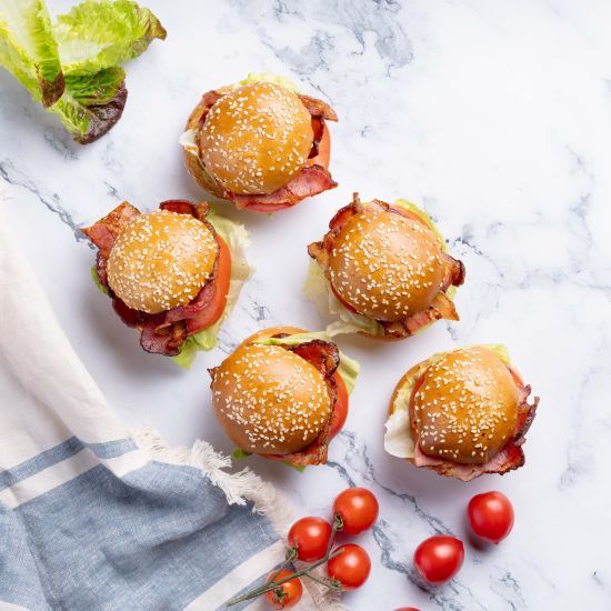 Mini bacon, lettuce and tomato seeded brioche rolls with bbq sauce