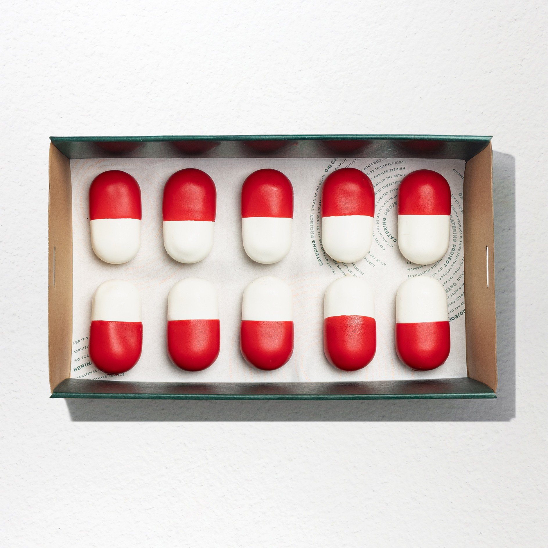 Oval Shaped dessert half red, half white like a pill