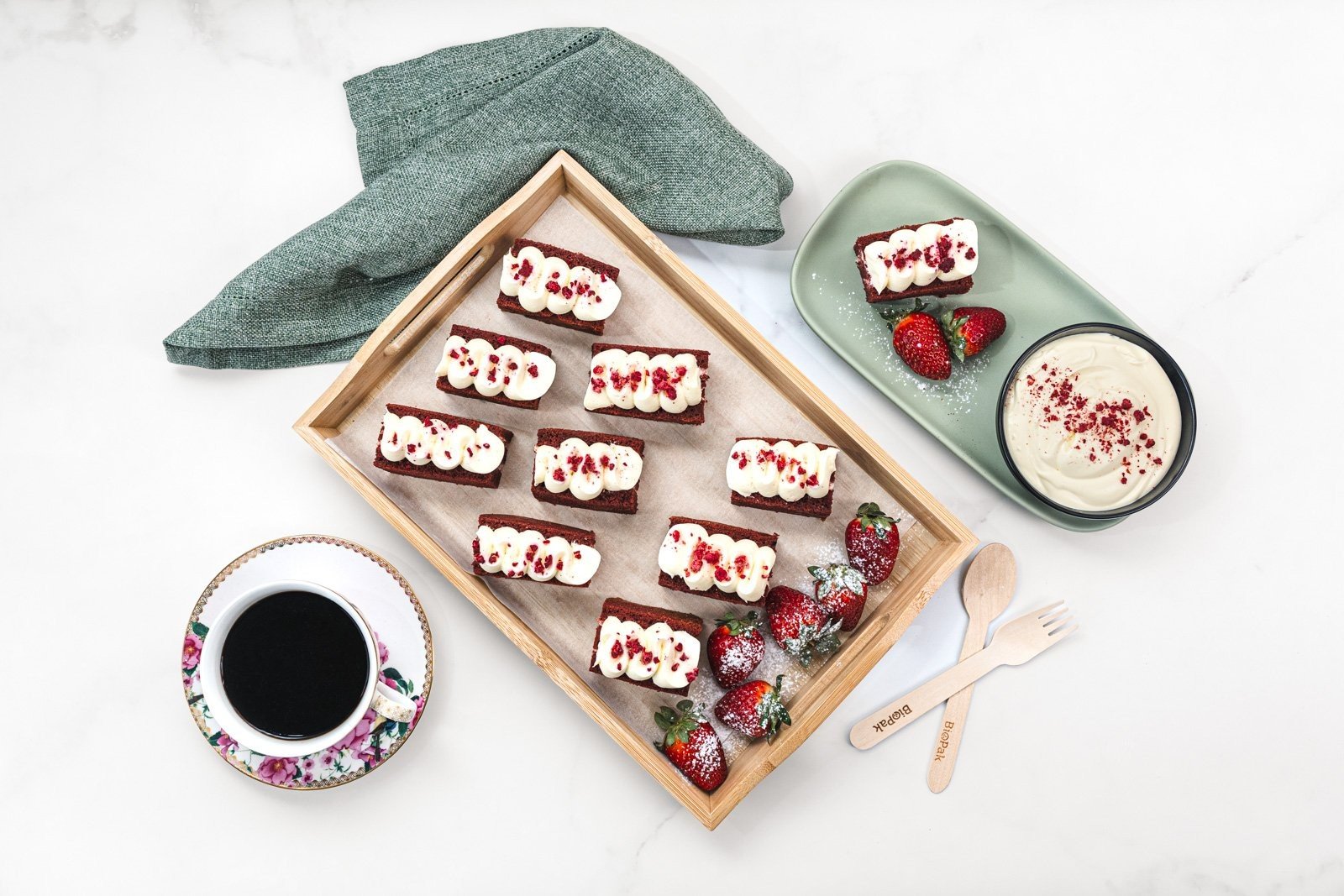 Red Velvet Cakes with Classic Crème Cheese Icing, served with Strawberries and Cream