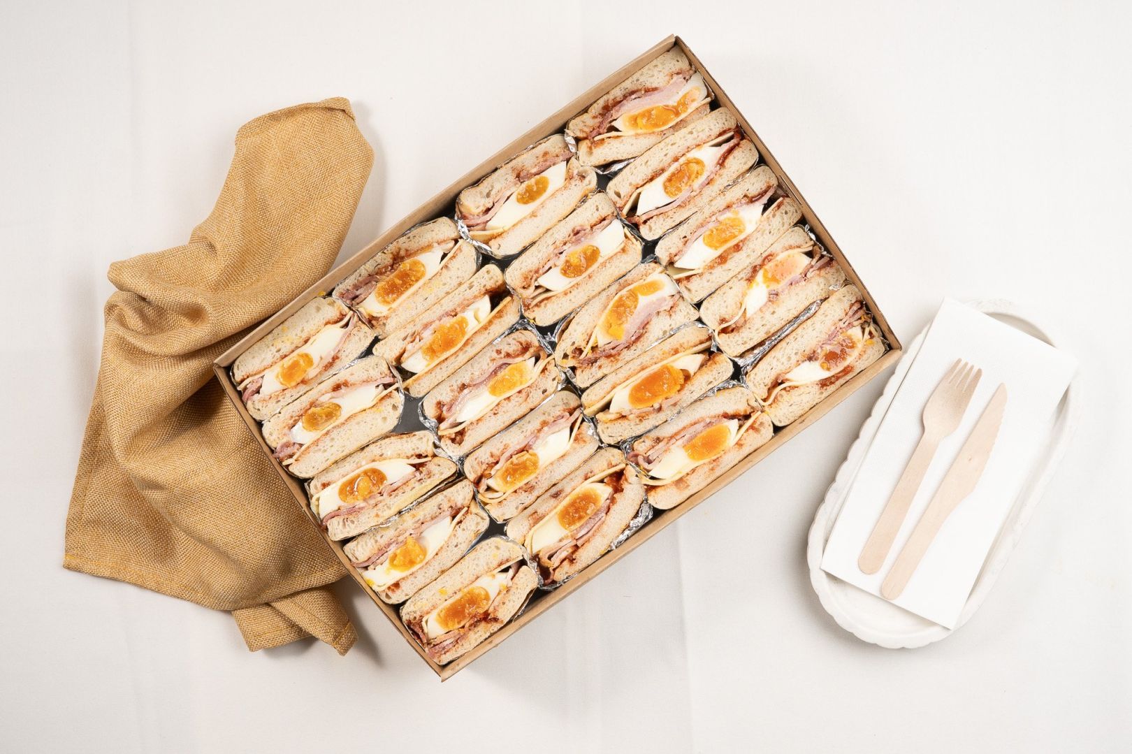 Shared Classic English Muffin Box Filled With Fried Egg, Bacon, Cheese And Tomato Relish