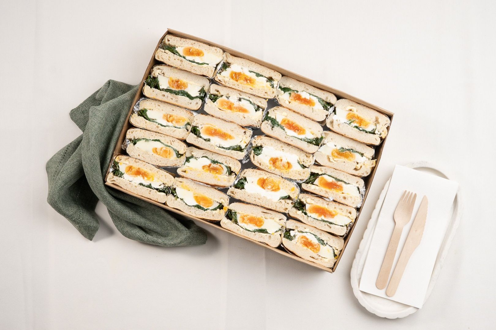 Shared Vegetarian English Muffin Box Filled With Fried Egg, Spinach, Feta And Za’atar