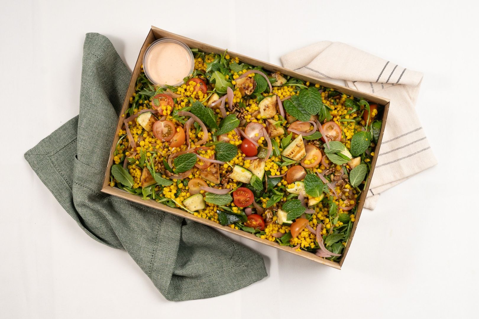 Nut Free, Turmeric Pearl Cous-Cous Salad, Chargrilled Zucchini, Cherry Tomatoes, Pickled Red Onions, Roquette, Spiced Seeds, Yoghurt & Harissa Dressing