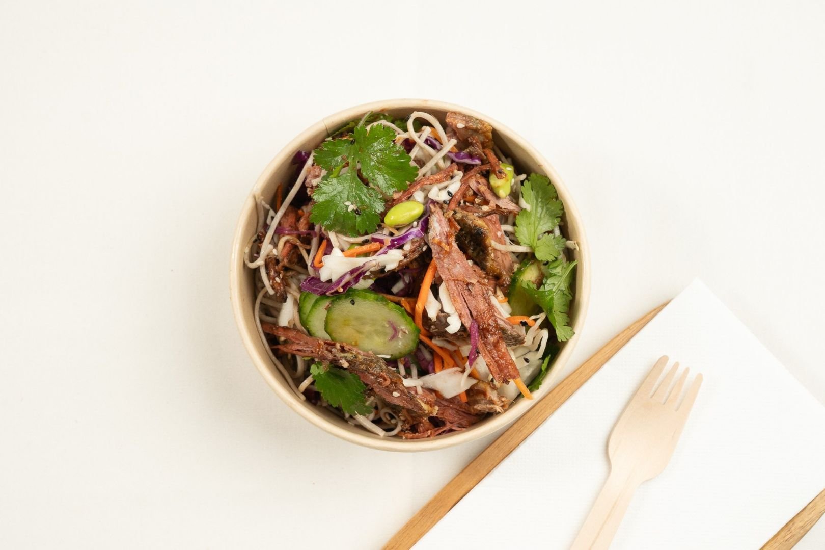Pulled Marinated Beef Brisket Soba Noodle Salad Bowl, Pickled Red Cabbage, Carrot, Cucumber, Edamame, Crispy Shallots,Sesame Seeds & Coriander With Soy and Mirin Dressing