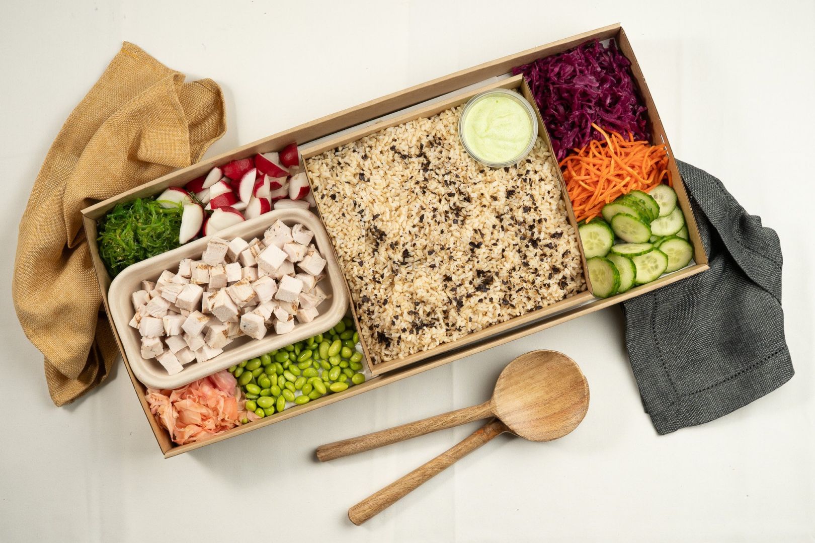 Protein Poke Box, Soy and Nori Brown Rice, Pickled Carrot, Wakame, Edamame, Pickled Red Cabbage, Cucumber, Radish, and Pickled Ginger