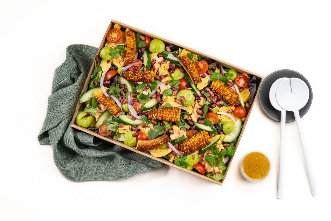 Baja Naked Burrito Salad, Chipotle chicken, BBQ Corn ribs, Mixed Salad Leaves, Smashed Tostadas, Avo puree, Cherry Tomatoes, Cucumber, Red Onion, Fresh Coriander, Toasted Seeds, Seeded Mustard &  Apple Cider Vinegar Dressing