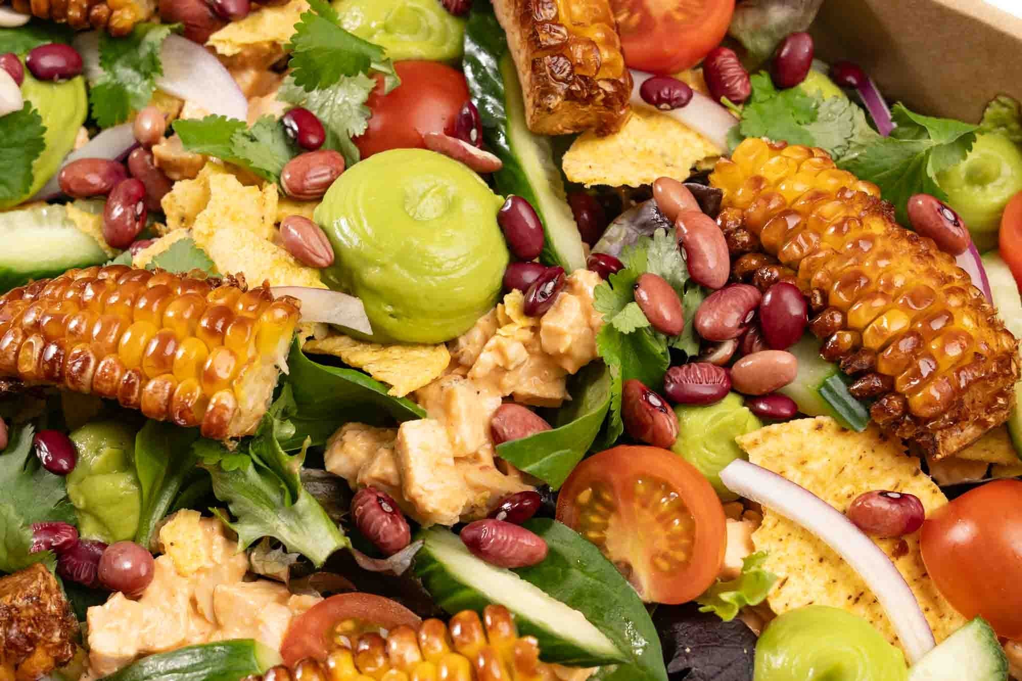 Baja Naked Burrito Salad Bowl, Chipotle chicken, BBQ Corn ribs, Mixed Salad Leaves, Smashed Tostadas, Avo puree, Cherry Tomatoes, Cucumber, Red Onion, Fresh Coriander, Toasted Seeds, Seeded Mustard &  Apple Cider Vinegar Dressing