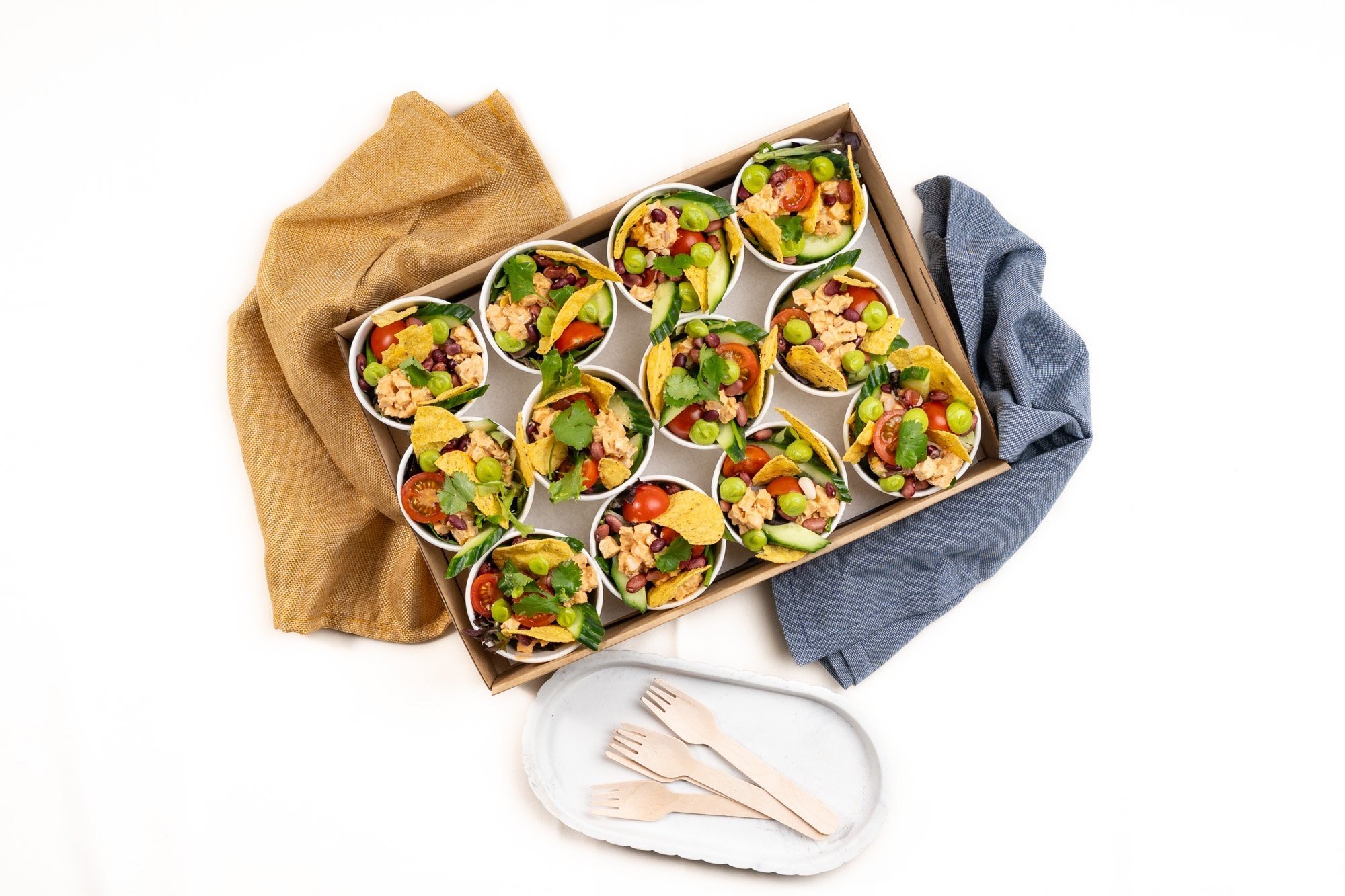 Baja Naked Burrito Salad Mini Cup, Chipotle chicken, BBQ Corn ribs, Mixed Salad Leaves, Smashed Tostadas, Avo puree, Cherry Tomatoes, Cucumber, Red Onion, Fresh Coriander, Toasted Seeds, Seeded Mustard &  Apple Cider Vinegar Dressing