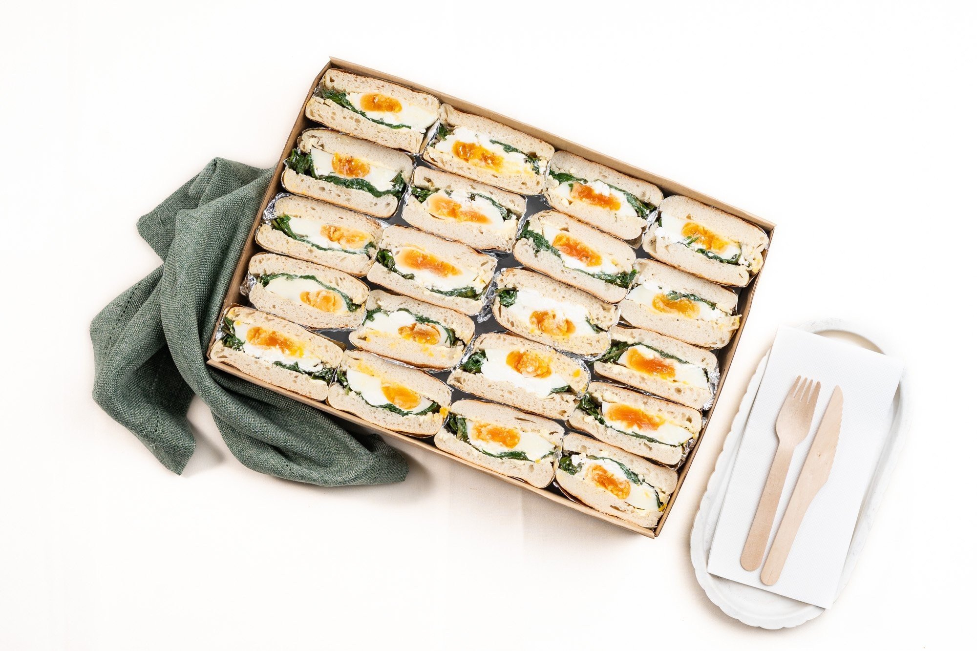 Shared Vegetarian English Muffin Box Filled With Fried Egg, Spinach, Feta And Za’atar
