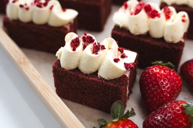 Red Velvet Cakes with Classic Crème Cheese Icing, served with Strawberries and Cream