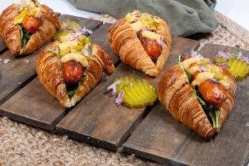 SAVOURY KRANSKY BABY CROISSANT- with grated cheese, fresh salad greens, hot kransky sausage, topped with our inhouse burger sauce & pickled red onion - hot