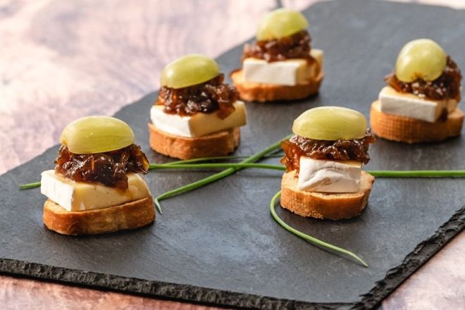 BRIE & ONION MARMALADE CROSTINI topped with a fresh grape (V)
