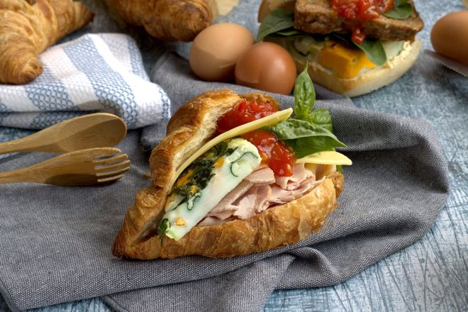 BREAKFAST LOADED LARGE CROISSANT with shaved ham, sliced cheese, frittata with egg-spinach-hash browns & creamy cheese sauce 