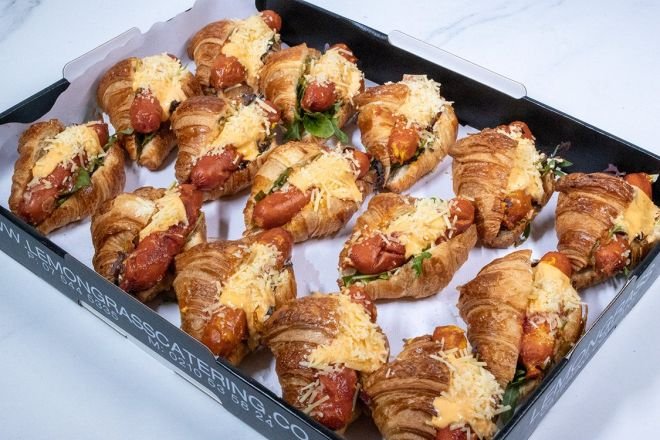 SAVOURY KRANSKY BABY CROISSANT- with grated cheese, fresh salad greens, hot kransky sausage, topped with our inhouse burger sauce & pickled red onion - hot