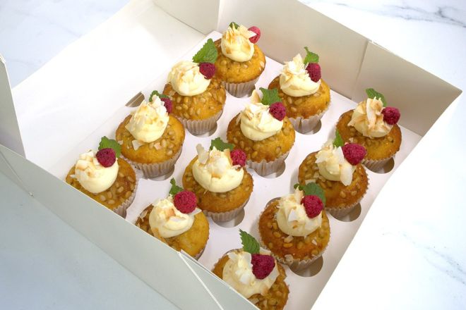 LEMON COCONUT CUPCAKE BOX (12) - topped with pinenuts, lemon mascarpone cream frosting, toasted coconut & whole freeze dried raspberry presented in a cupcake box with lid 