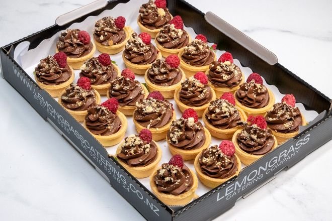 CHOCOLATE AND RASPBERRY TART PLATTER - raspberry coulis topped with whipped chocolate ganache, caramelized white chocolate & whole freeze dried raspberry in sweet tart shells 