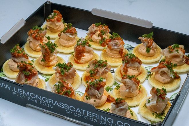 PROSCIUTTO BLINI with whipped sunblush tomato cream cheese pesto canape 