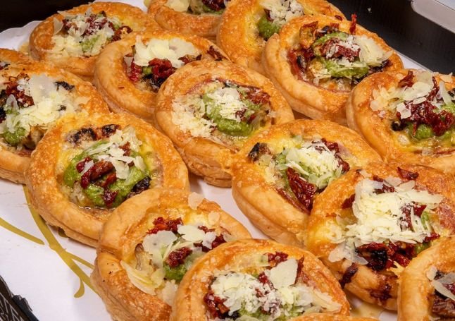 MEDITERRANEAN PUFFS - Salami, marinated artichokes, roasted red pepper, fresh herbs, cheese & pesto drizzle in flakey round pastry 