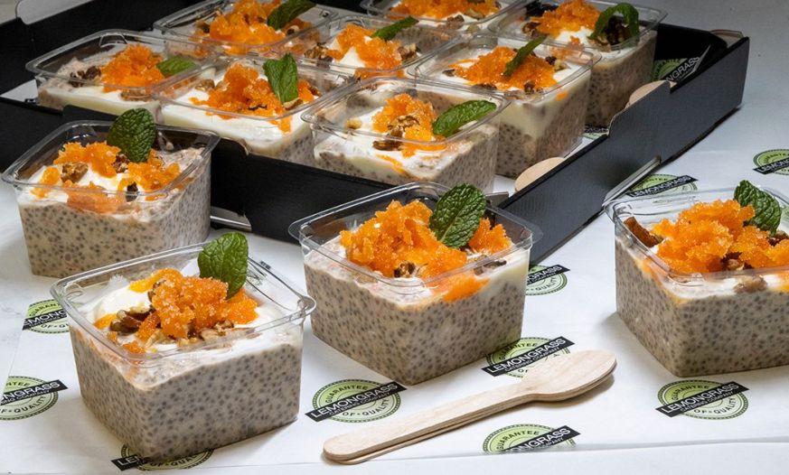 OVERNIGHT OATS Carrot Cake Style with grated carrot, greek yoghurt, sultanas, diced pineapple, and crushed walnuts - served with wooden spoons 