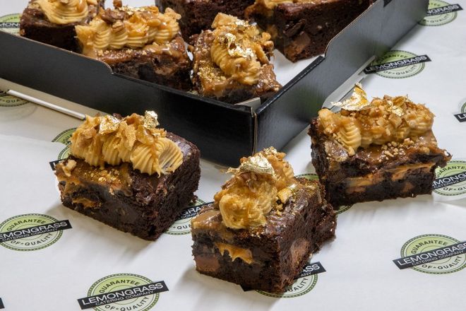 CARAMEL CHOCOLATE BROWNIE - Our triple chocolate & walnut brownie folded through salted caramel filling topped with salted caramel icing swirls 