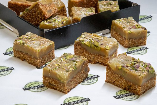 GINGER OAT SLICE - with rolled oat base & crystalized ginger topped with a rich ginger icing topped with crushed nuts & coconut 