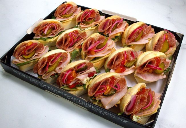 MUFFERLETTA - Midi round filled roll with salami, shaved ham, sliced cheese, salad greens, pickled red onions & relish 