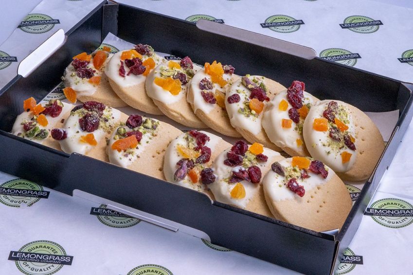 SHORTBREAD BISCUITS dipped in white chocolate & decorated with cranberry, pistachio & diced dried apricots
