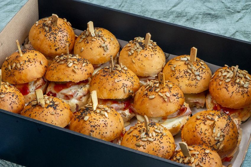 HAM AND CHEESE HOT MIDI ROLLS with garlic butter, ham, cheese, capsicum & apricot relish, gherkins & heated in oven - served hot