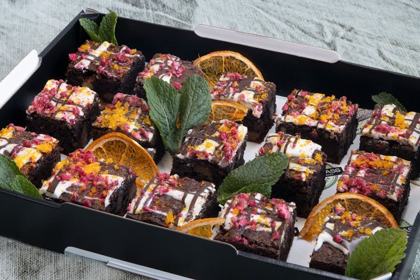 TRIPLE CHOCOLATE & WALNUT BROWNIE BITES topped with white & dark chocolate drizzle & freeze dried raspberries  - Our signature bake - Bite Size 