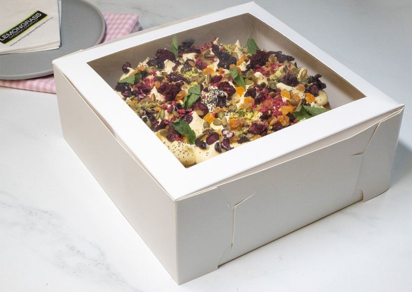 CARROT & WALNUT CAKE  - 23cm round - double cake layer filled & topped with with citrus cream cheese frosting and decorated with dried apricots, cranberries, pistachios, seeds & toasted walnuts. Presented in a cake box 