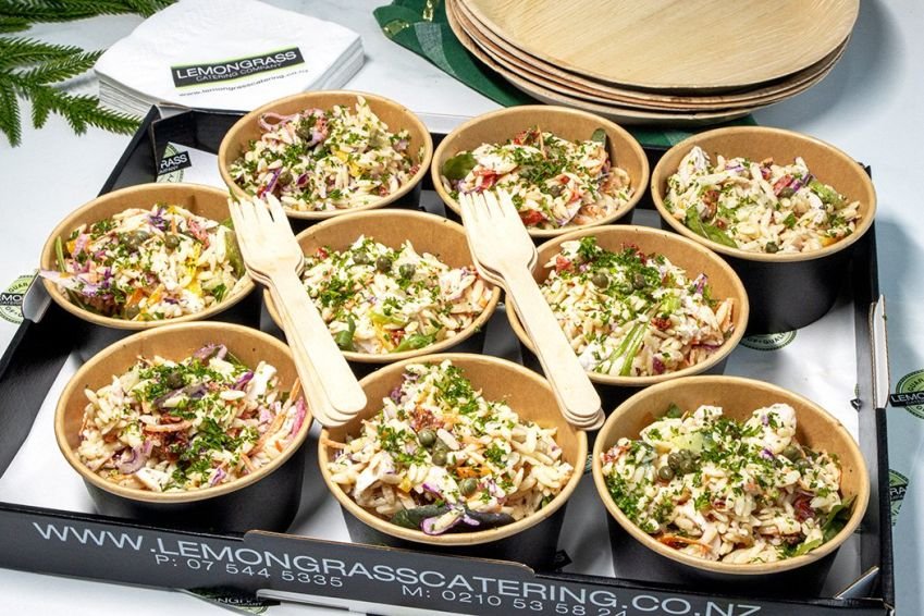 MEDITERRANEAN CHICKEN ORZO PASTA SALAD TUBS - sunblush tomatoes, seasonal fresh greens, cucumber, red onion, olives, feta & zesty lemon olive vinaigrette. Individual round salad tubs with wooden fork 