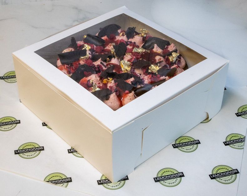 CHOCOLATE AND RASPBERRY CAKE - 23cm round - double cake layer filled & topped with raspberry buttercream, drizzled with berry couli and decorated with freeze dried raspberries & Whitakers chocolate shards. Presented in a cake box