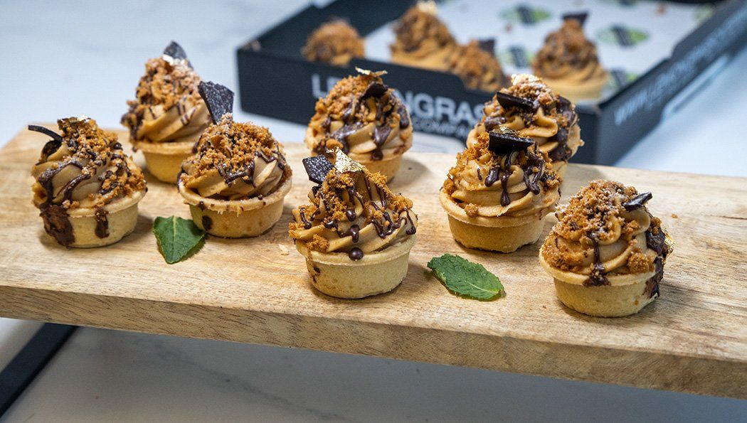 SALTED CARAMEL BISCOFF TART Platter - salted caramel filling topped with caramel mascarpone & dollop of caramel topped with crushed biscoff cookies in sweet tart shells 