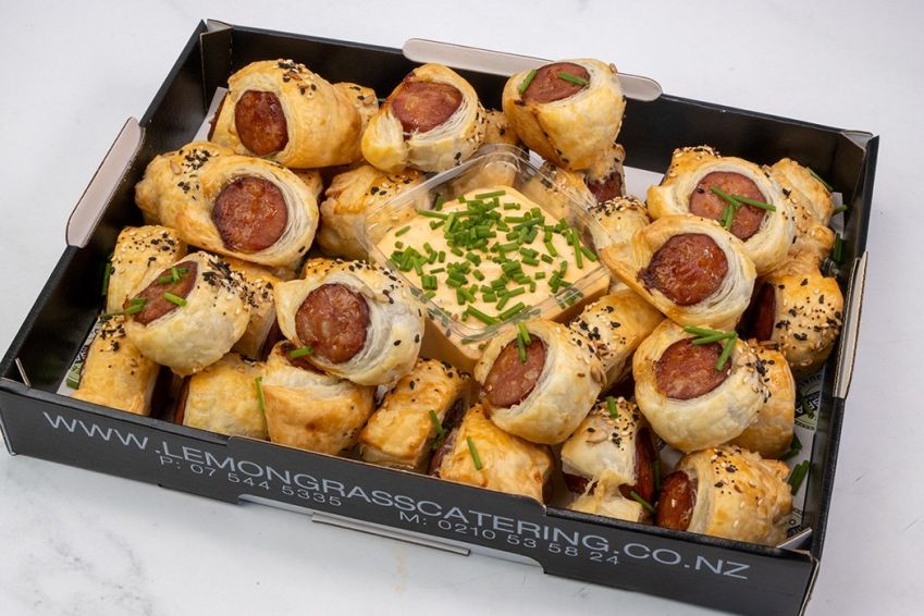 CHORIZO PUFFS PLATTER - 40 - Smokey chorizo bites wrapped in flakey pastry with house made coarse grain honey & mustard dip sauce. 40 bites per platter. Served warm 
