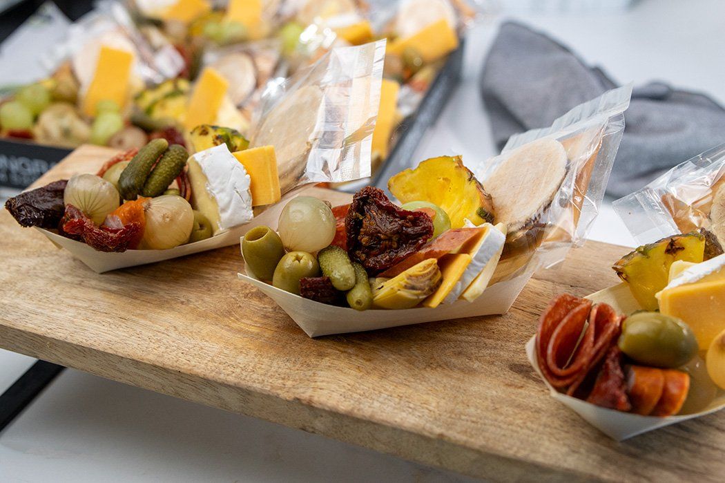 CHARCUTERIE BOATS - Selection of fine cured meats, artisanal cheeses, fresh fruits, antipasti and crispy crackers served in individual bowls 