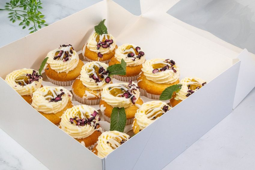 BLUEBERRY AND PASSIONFRUIT CUPCAKE BOX (12) - Vanilla bean cupcake filled with blueberry compote topped with passionfruit buttercream and passionfruit compote