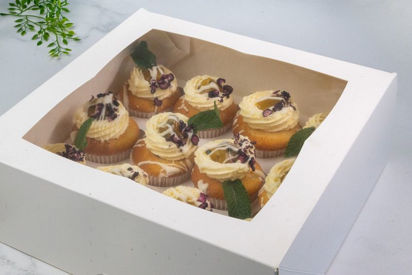 BLUEBERRY AND PASSIONFRUIT CUPCAKE BOX (12) - Vanilla bean cupcake filled with blueberry compote topped with passionfruit buttercream and passionfruit compote