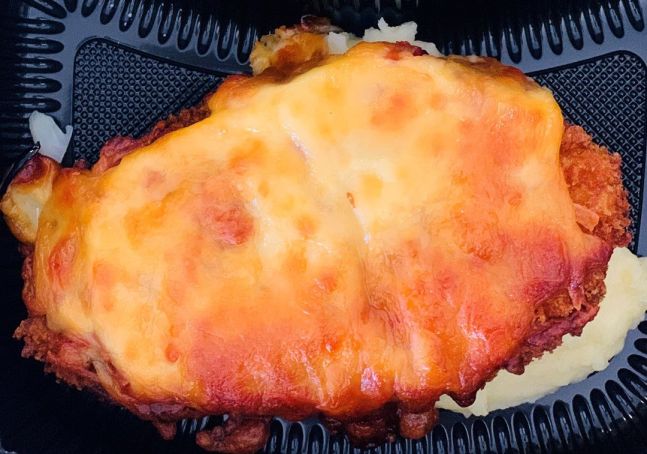 Chicken parmigiana with mustard mash and greens