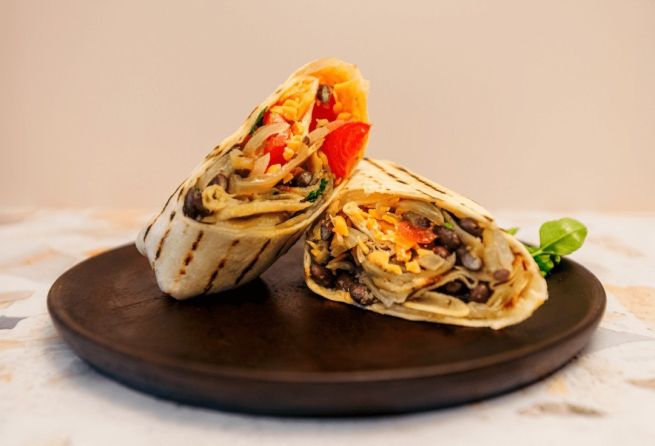 Burrito, served warm - Black beans, cherry tomato, & potato, sautéed onions, vegan cheese vgn / nf