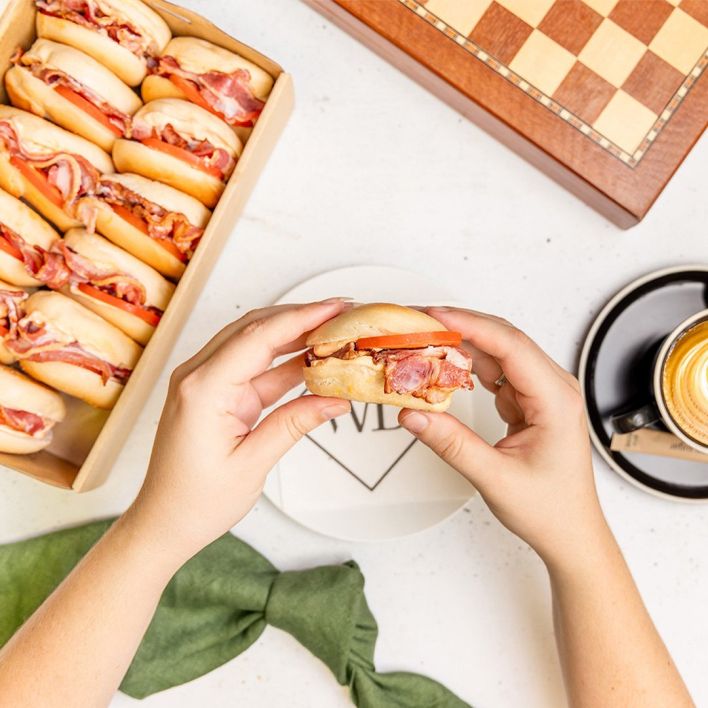 Box of mini spicy bacon bagels with tomato