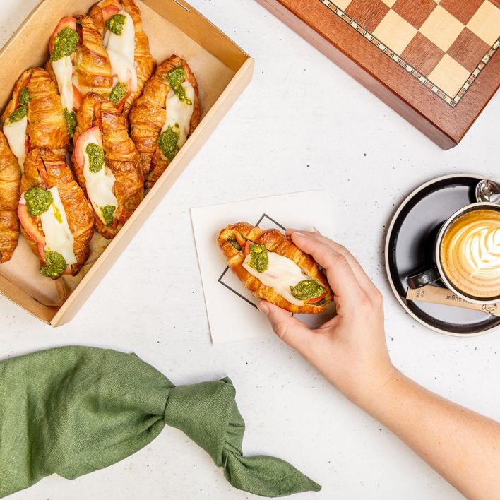 Box of mini caprese croissants with tomato, mozzarella & pesto