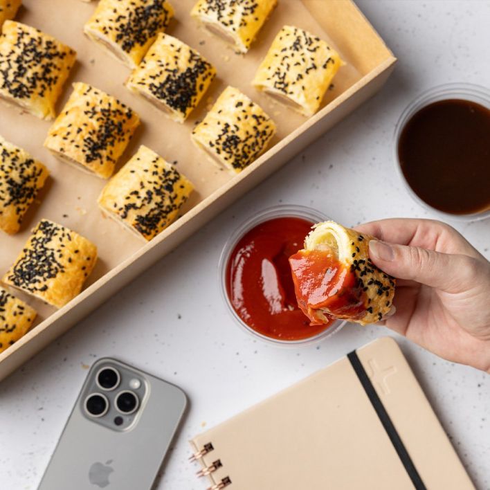 Box of homemade mini sausages rolls with tomato & BBQ dipping sauces