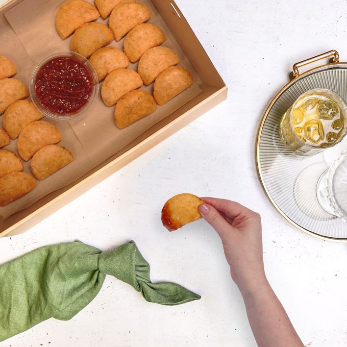 Box of black bean empanadas with tomato relish dipping sauce